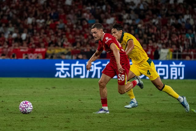 Liverpool’s Florian Wirtz runs past AC Milan’s Samuele Ricci 