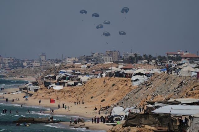 Humanitarian aid is airdropped to Palestinians over the central Gaza Strip