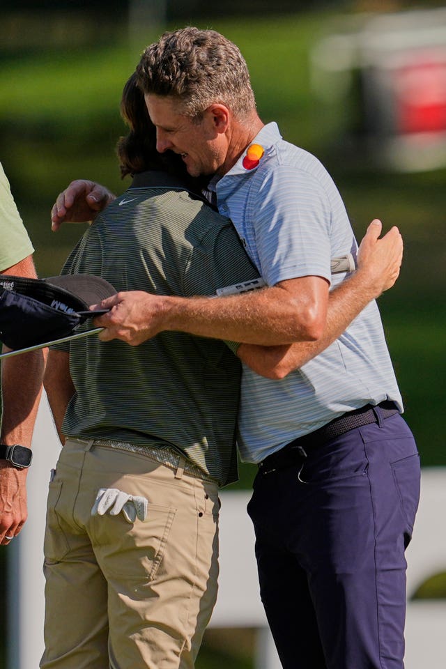 Justin Rose, right, hugs Tommy Fleetwood on the 18th green after the third round of the FedEx St. Jude Championship
