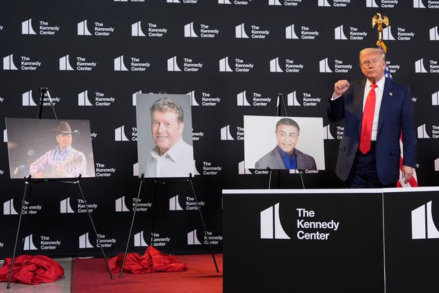 President Donald Trump stands beside photos of Kennedy Centre Honours nominees, from left country music star George Strait, actor-singer Michael Crawford and Rocky actor Sylvester Stallone
