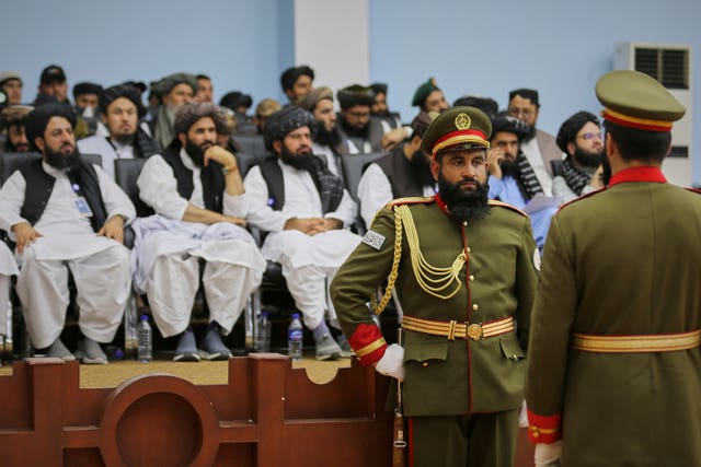 Soldiers affiliated to the Defence Ministry stand in guard during a meeting of delegates from across Afghanistan marking the start of celebrations of the fourth anniversary of the US withdrawal and the start of Taliban rule, at Loya Jirga Hall in Kabul 