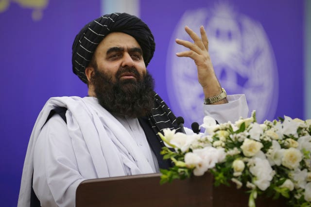 The Taliban’s foreign minister Amir Khan Muttaqi addresses delegates from across Afghanistan during a meeting marking the start of celebrations of the fourth anniversary of the US withdrawal and the start of Taliban rule, at Loya Jirga Hall in Kabul 