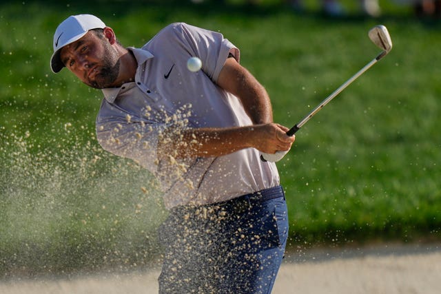 Scottie Scheffler hits from a bunker