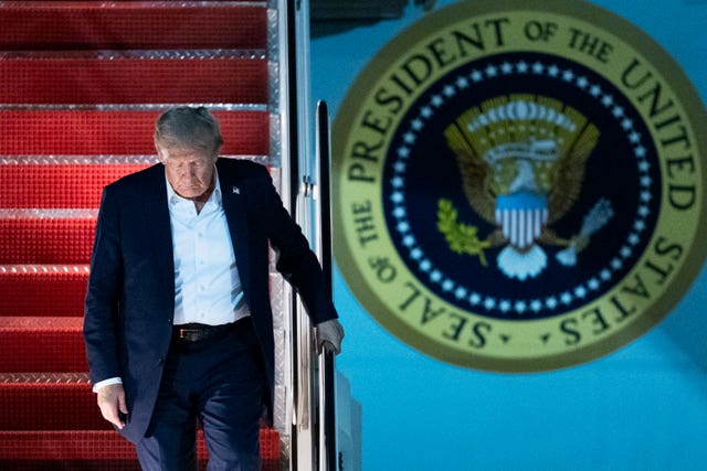 US President Donald Trump disembarks Air Force One 
