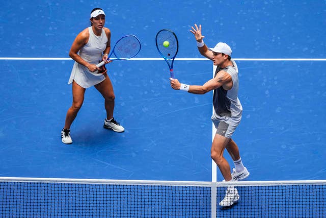 Jack Draper, right, hits a volley playing with Jessica Pegula