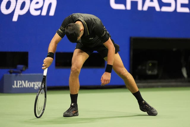 Novak Djokovic bends over after a long rally