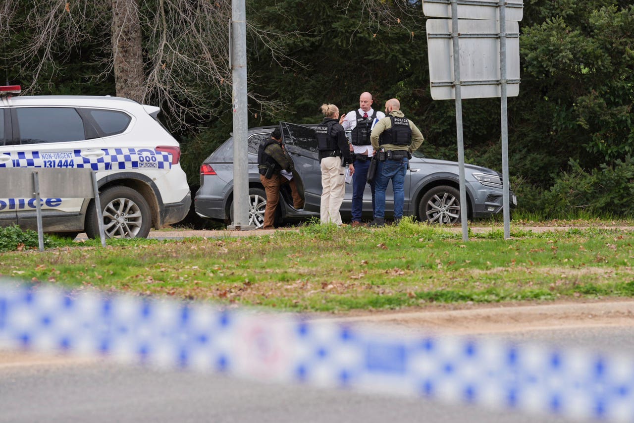 Manhunt under way after two police officers shot dead in rural ...