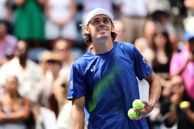 Alex De Minaur smiles after his win