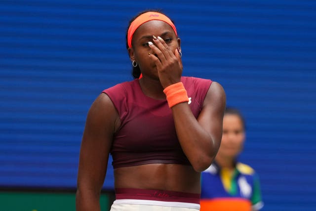 Coco Gauff covers her face