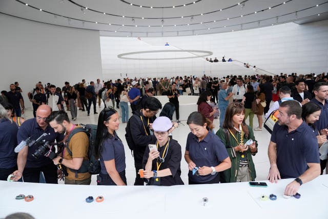 Attendees look at Apple’s new products