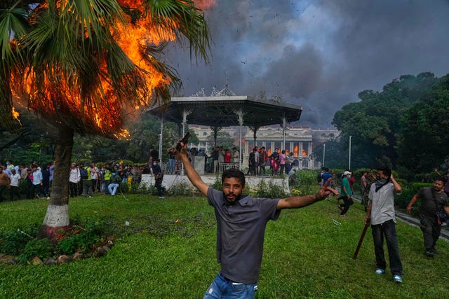 Protesters at the Singha Durbar, the seat of Nepal’s government’s various ministries and offices, after it was set on fire 