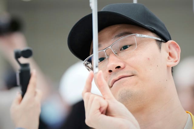 A man takes a closer look at an iPhone Air 