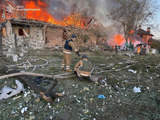 Rescue workers put out a fire in a house destroyed by a Russian strike on a residential neighbourhood in Zhytomyr region, Ukraine 