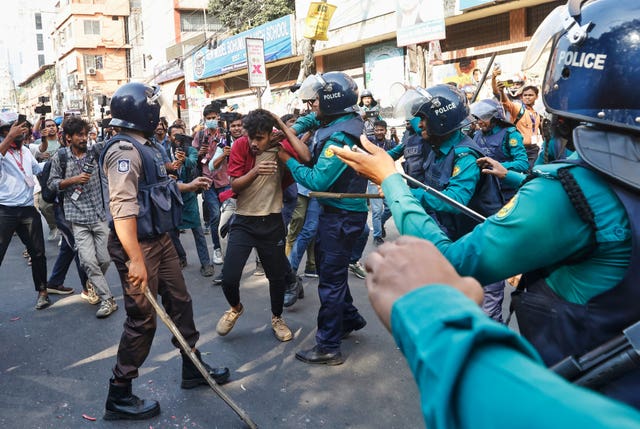 Police use batons to disperse protesters gathered outside the demolished residence of Sheikh Mujibur Rahman, Bangladesh’s former leader and the father of the country’s ousted prime minister Sheikh Hasina after the verdict against Hasina, in Dhaka, Bangladesh