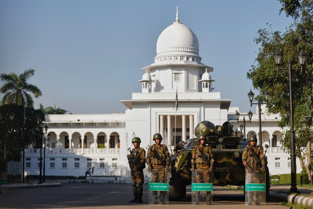 Bangladeshi army soldiers stand guard outside the Supreme Court ahead of the verdict against ousted prime minister Sheikh Hasina, in Dhaka, Bangladesh