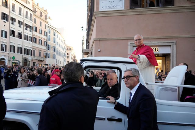 Crowds look on as the pope is paraded in his popemobile
