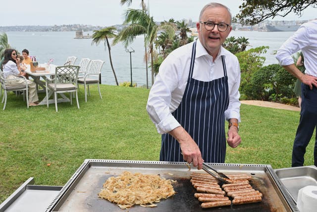 Australian Prime Minister Anthony Albanese cooking on a barbecue
