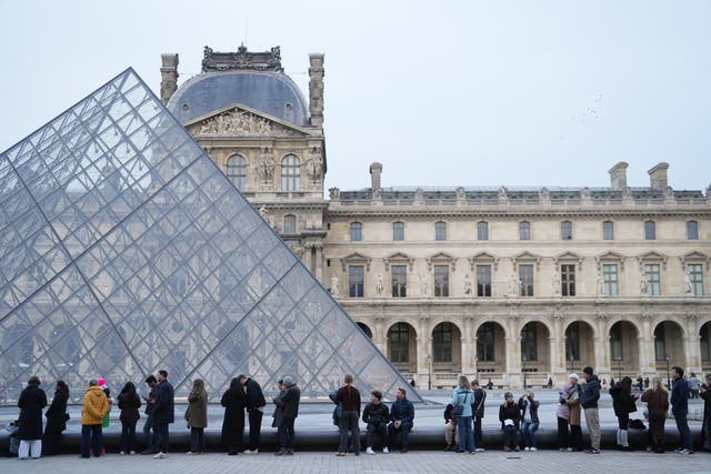 People wait for the Louvre museum to open  (Thibault Camus/AP)