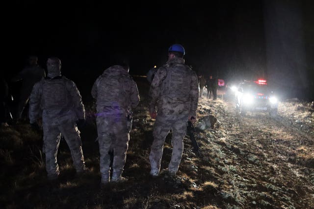 Turkish soldiers and rescue teams search for the remains of the jet 
