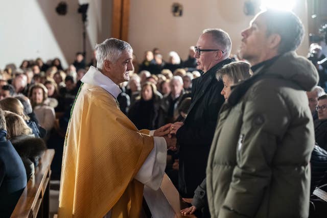 Bishop and mourners at Mass