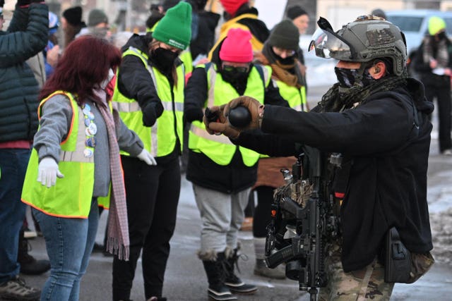 A law enforcement officer using a chemical agent on protesters
