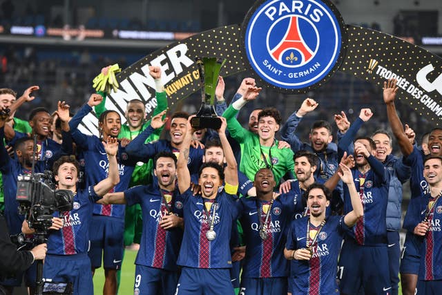 PSG’s Marquinhos holds up the trophy and celebrates with team-mates after the French Super Cup victory over Marseille
