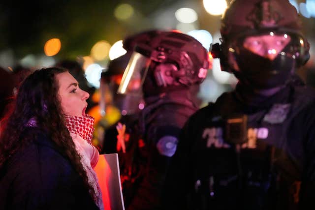  A protester yells at a Portland police officer