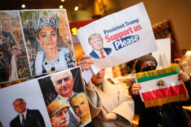 People hold up photos of Reza Pahlavi, the son of Iran’s toppled Shah Mohammad Reza Pahlavi, during a small demonstration in Istanbul in support of the nationwide mass protests in Iran against the government 