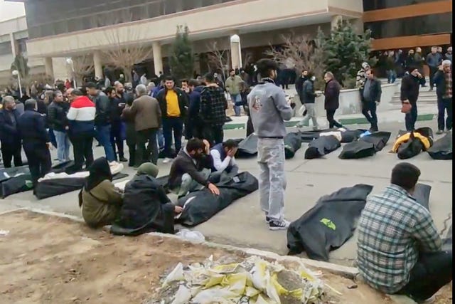 A screen grab from videos circulating on social media purportedly showing images from a morgue with dozens of bodies and mourners after a crackdown on the outskirts of Iran’s capital, in Kahrizak, Tehran Province 