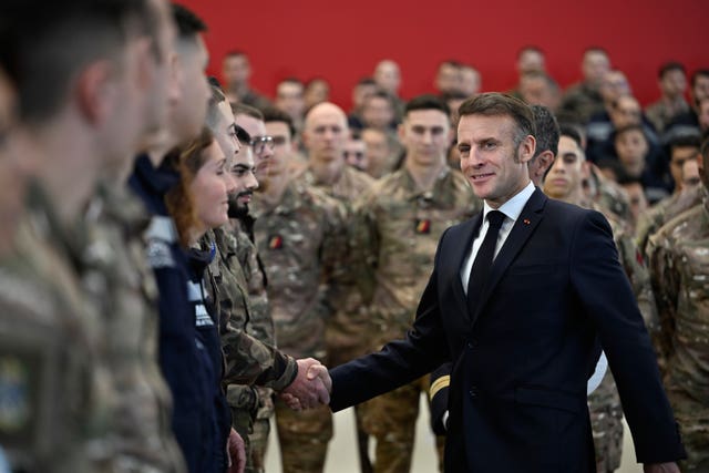 Emmanuel Macron shakes a soldier's hand