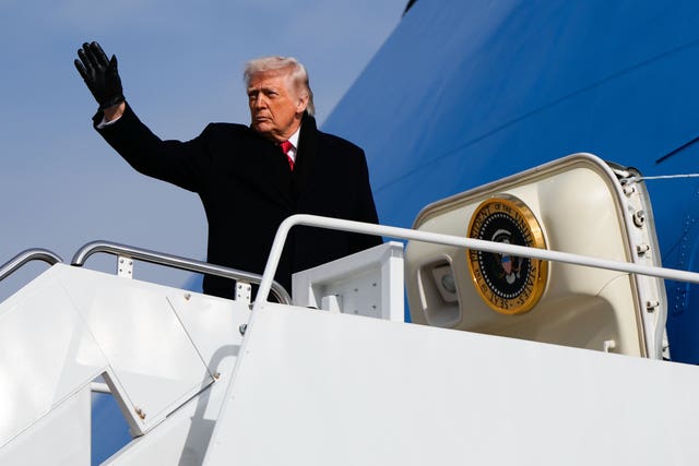 President Donald Trump waves while boarding Air Force One 