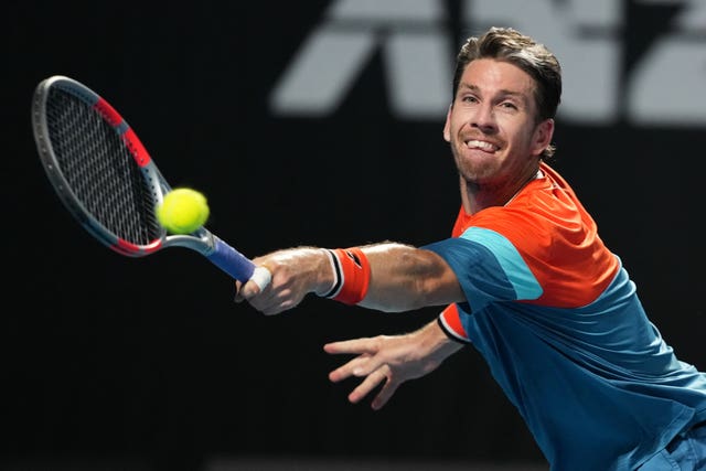 Cameron Norrie stretches for a backhand