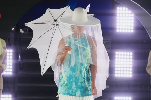 Naomi Osaka walks onto Rod Laver Arena for her first-round match against Antonia Ruzic dressed in an extravagant jellyfish-inspired outfit 