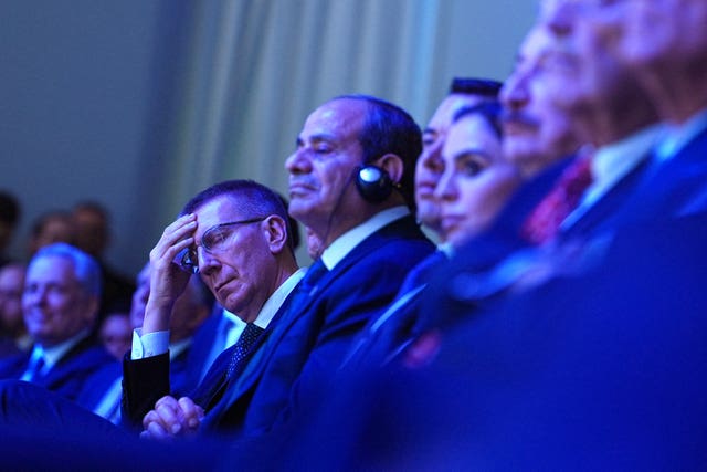Latvia’s President Edgars Rinkevics, centre left, listens to Mr Trump's address