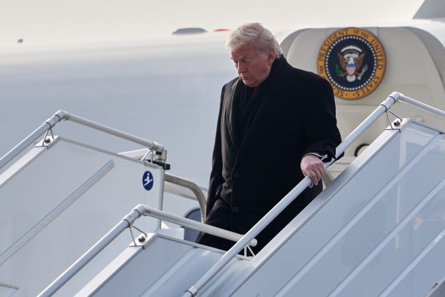US president Donald Trump steps off Air Force One after arriving in Switzerland 