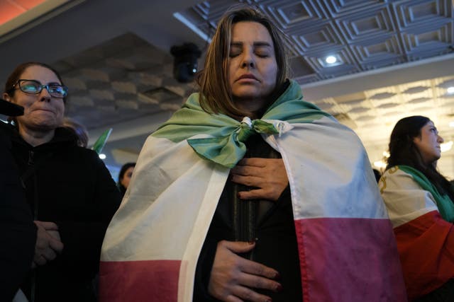 A woman wrapped in an Iranian flag