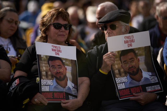 People hold up pictures of dead Israeli hostage Ran Gvili