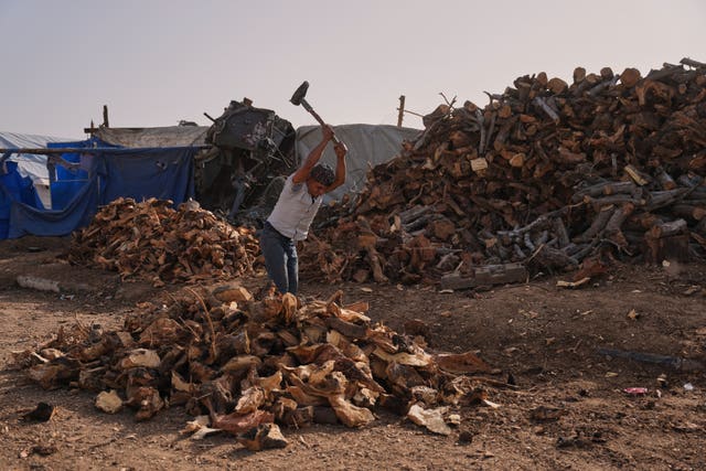 A Palestinian man chopping wood