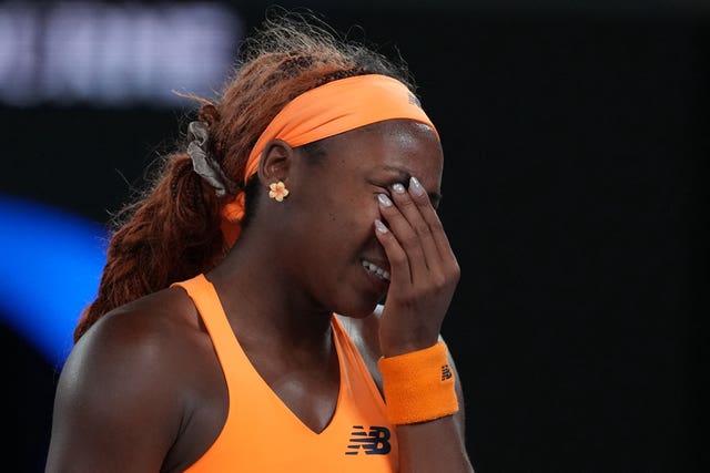 Coco Gauff holds her face