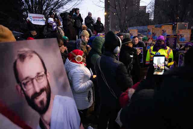 A photo of Alex Pretti is displayed during a vigil