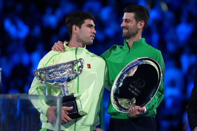 Carlos Alcaraz, left, and Novak Djokovic hold their trophies
