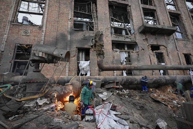 Workers clean up damage at Darnytsia Thermal Power Plant after a Russian attack in Kyiv, Ukraine 