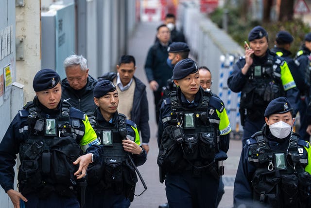 Police officers stand guard outside the West Kowloon Magistrates’ Courts ahead of the sentencing