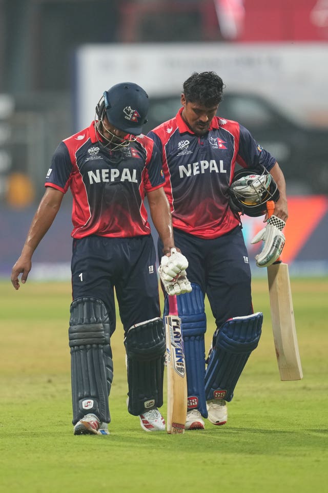 Nepal’s Lokesh Bam and Karan KC walk back to the pavilion after their defeat to England