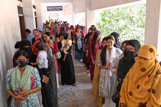 Women queue up to cast their vote at a polling station 