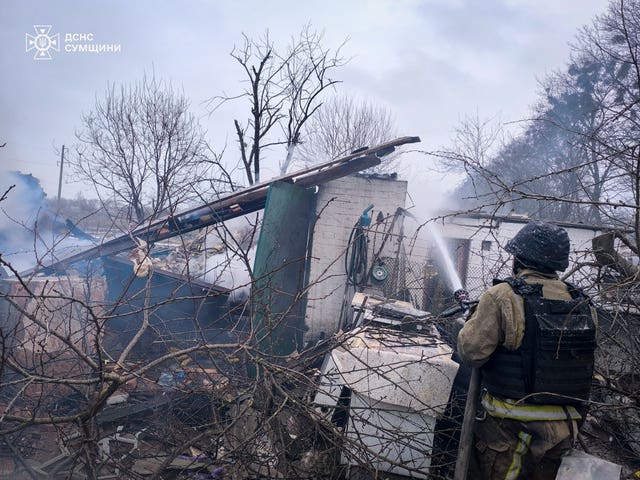 A firefighter puts out a fire following a Russian air attack in Sumy region, Ukraine