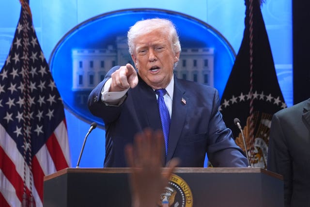 President Donald Trump points to a reporter during a press briefing at the White House 