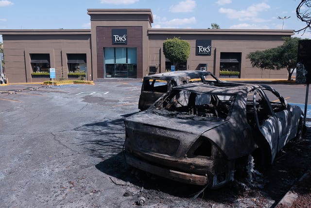 Charred vehicles outside a shopping centre in Guadalajara