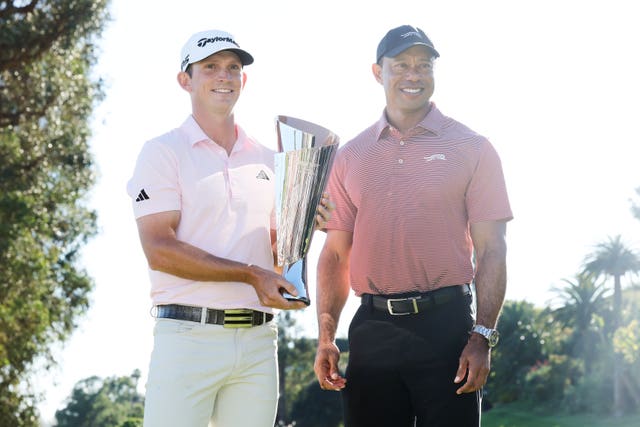 Jacob Bridgeman, left, poses with Tiger Woods 