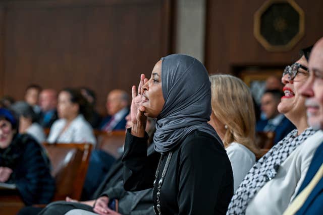 Democrat representative Ilhan Omar reacts during the speech